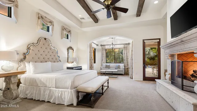 a room with a bed mirror and window