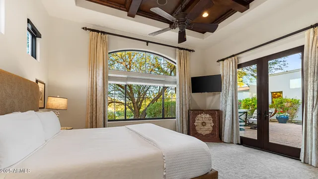 a bedroom with a bed and a television