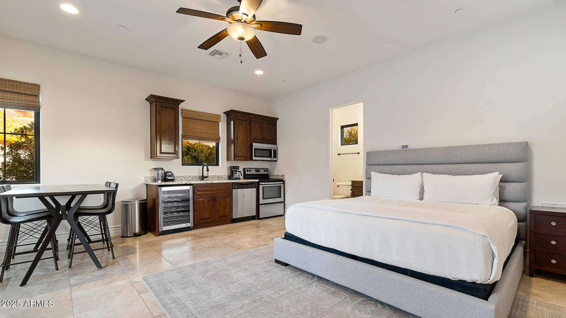 7120 North Quartz Mountain Road Paradise Valley, AZ 85253 - Photo 19 of 28 a bedroom with a bed and a chandelier