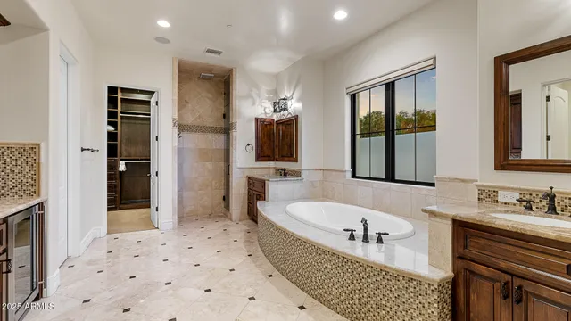 a bathroom with a bathtub sink and mirror