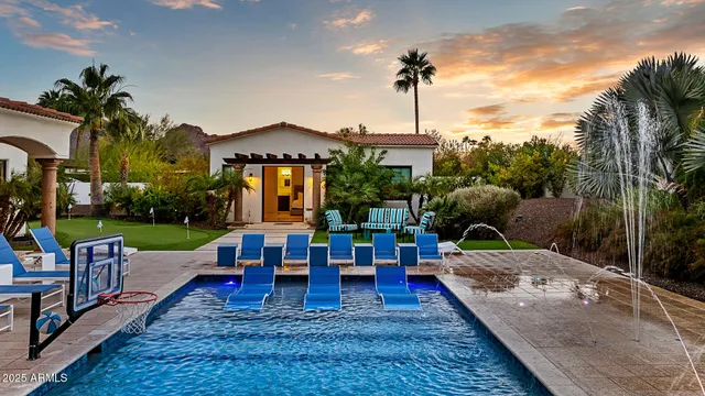 a view of a house with backyard and a patio