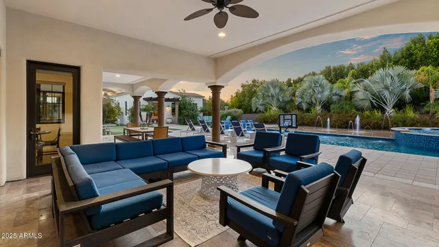 a living room with patio furniture and a potted plant