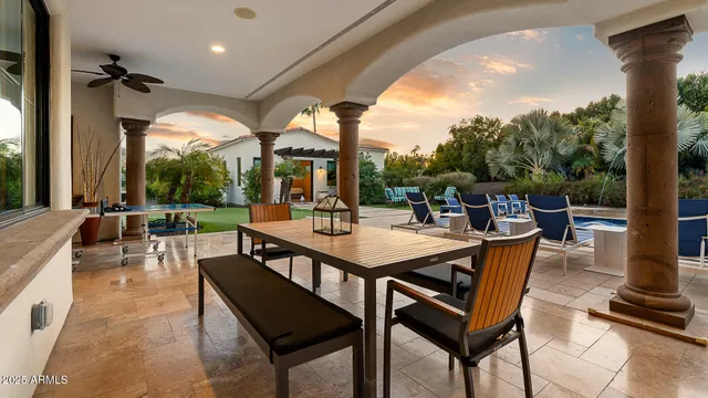 a view of a patio with a dining table and chairs