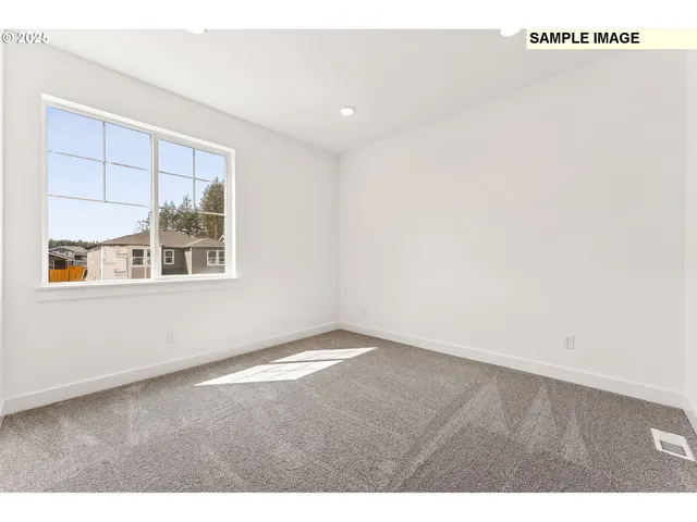 a view of a kitchen with lot of white cabinets