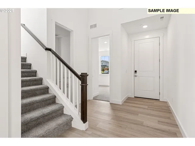 a view of an entryway with wooden floor