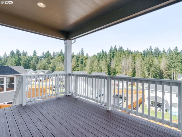 a living room with furniture kitchen view and a large window