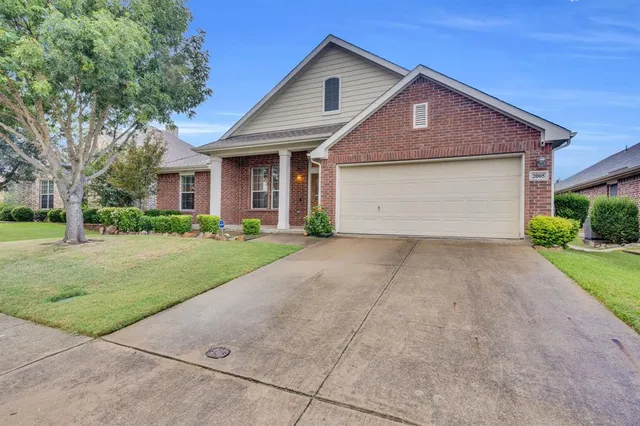 a front view of house with yard and trees