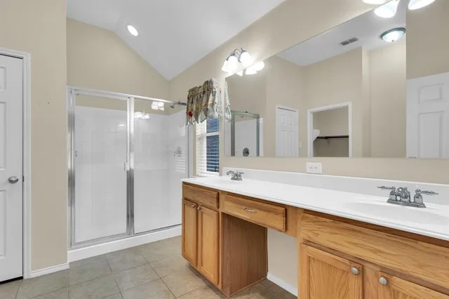 a spacious bathroom with a granite countertop sink a toilet and a mirror