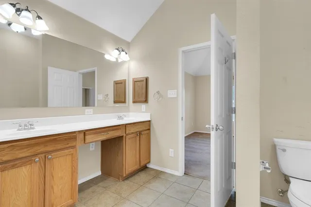 a spacious bathroom with a sink a mirror and a shower