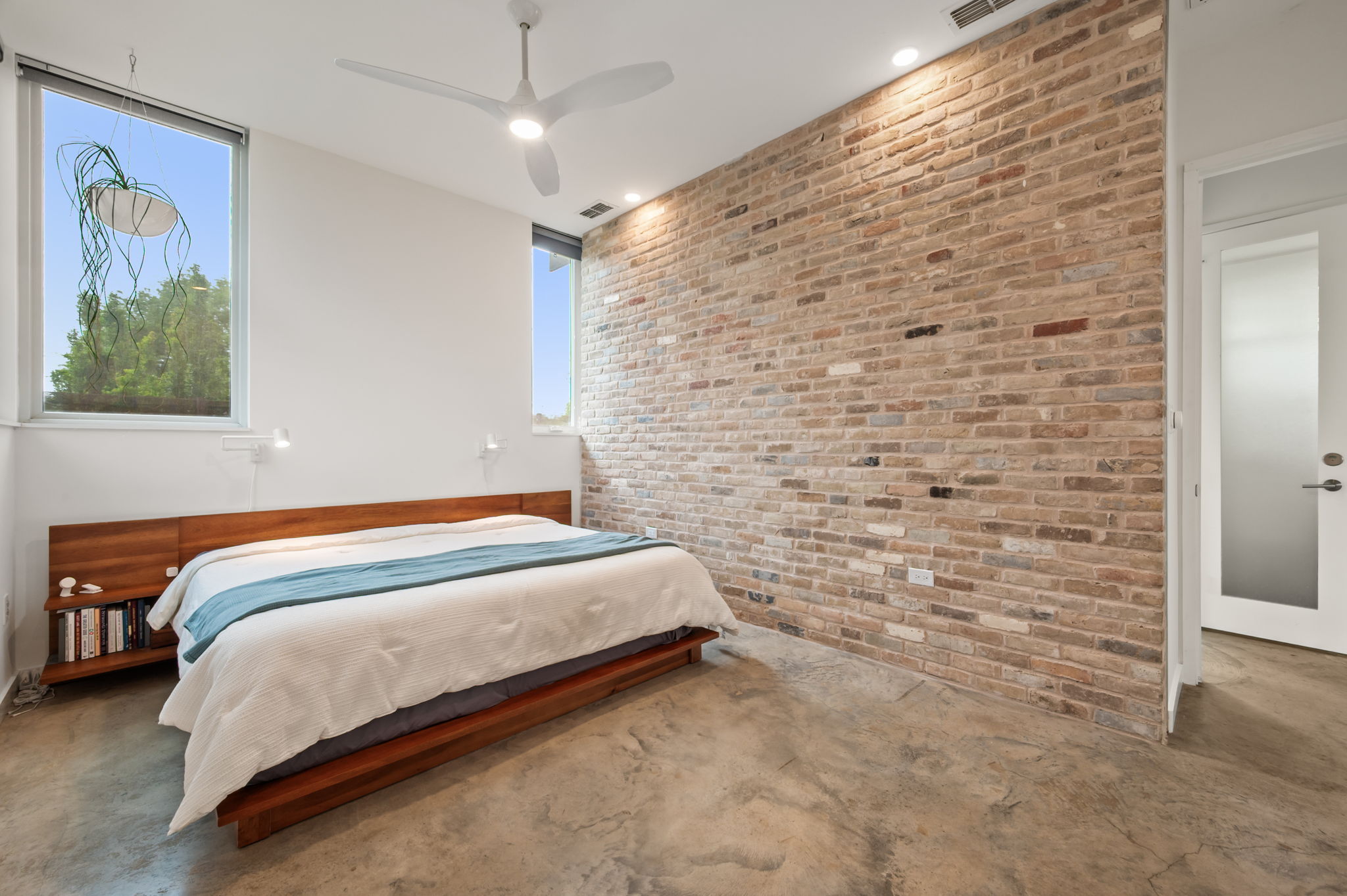 534 Old McDade Road Elgin, TX 78621 - Photo 14 of 40 Expansive Primary Suite features ten foot ceilings, motorized window treatments and a stunning, antique brick accent wall