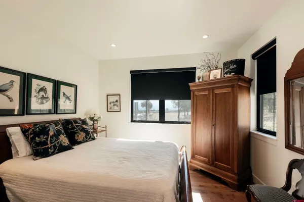 a large bed sitting in a bedroom next to a window