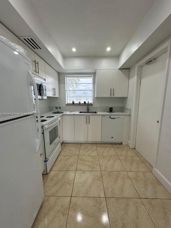 7610 Southwest 82nd Street, Unit J208 Miami, FL 33143 - Photo 5 of 13 a kitchen with stainless steel appliances granite countertop a sink stove and refrigerator