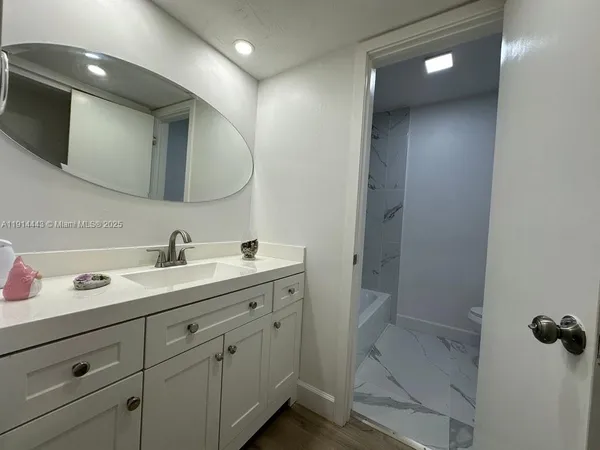a bathroom with a double vanity sink and mirror