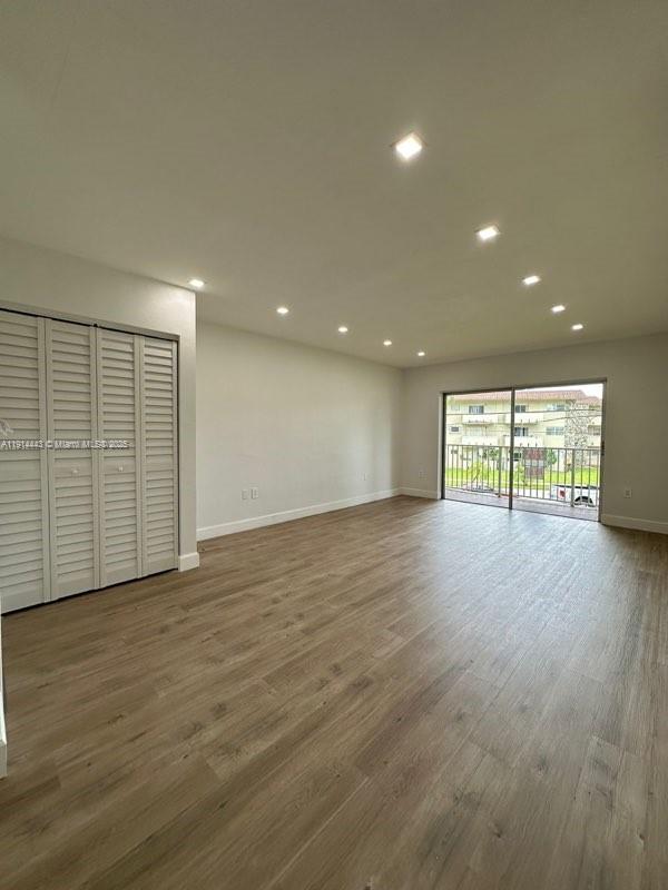 7610 Southwest 82nd Street, Unit J208 Miami, FL 33143 - Photo 8 of 13 an empty room with wooden floor and windows