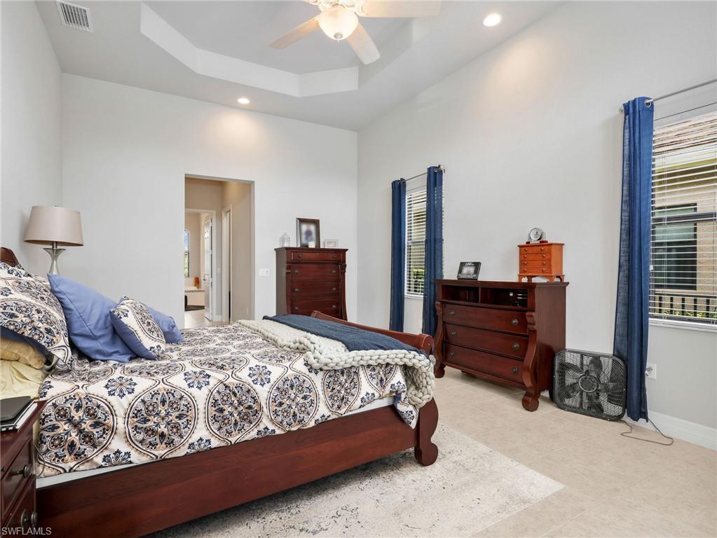 2756 Crystal Way Naples, FL 34119 - Photo 13 of 50 a bedroom with a bed and dresser with mirror