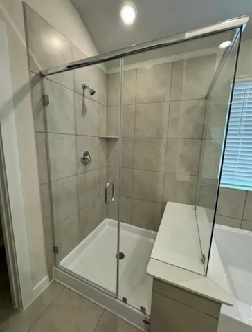 a bathroom with a bathtub sink and mirror