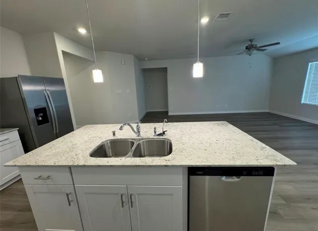 a view of kitchen with sink microwave and refrigerator