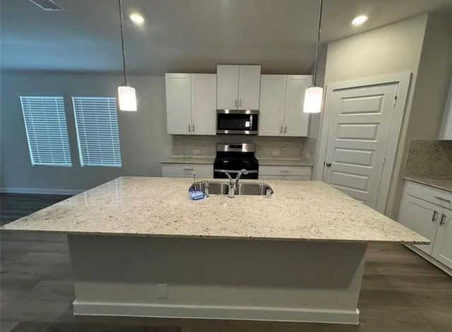 an empty room with a empty space and windows