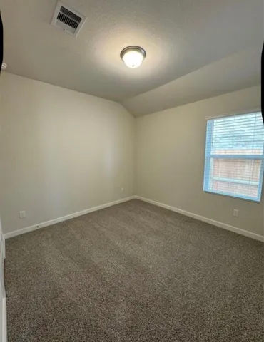 an empty room with closet and a sink