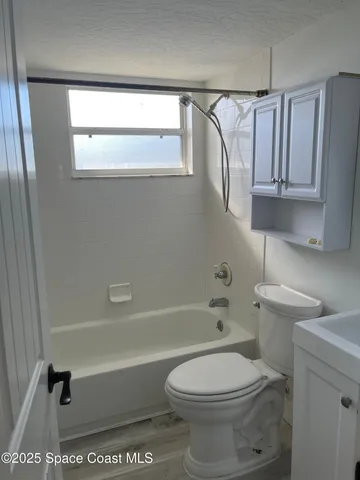 a bathroom with a toilet a sink and bathtub