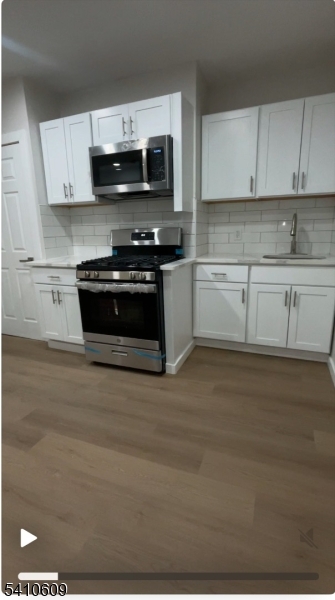 a kitchen with granite countertop a stove and a sink