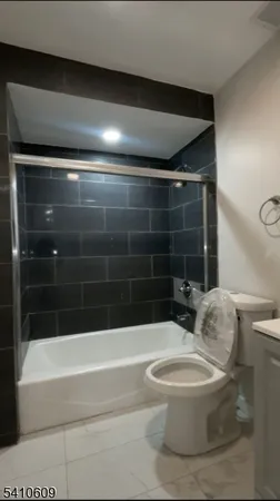 a bathroom with a toilet and a bathtub