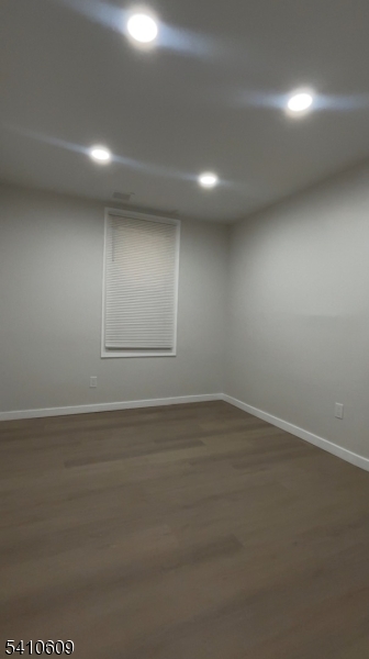 178 3rd Street, Unit 2 Elizabeth Port, NJ 07206 - Photo 3 of 3 an empty room with wooden floor and windows