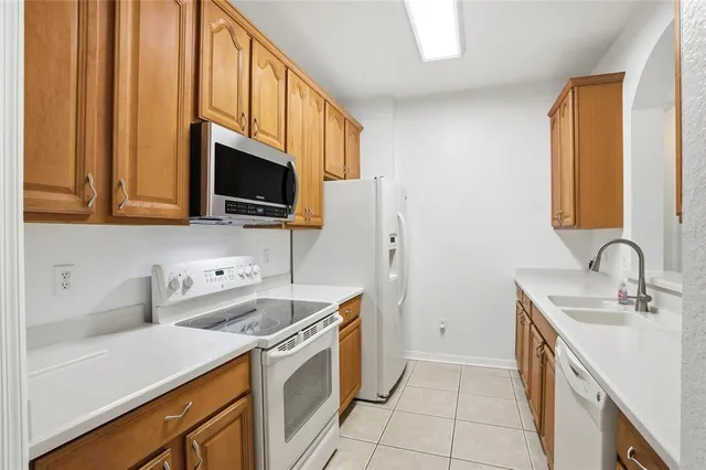 a view of a room with a windows and ceiling fan