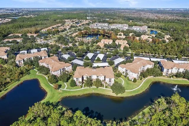 an aerial view of a house with a yard lake view and mountain view