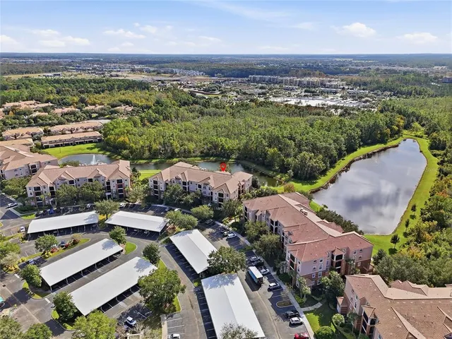a view of a patio with table and chairs a barbeque with potted plants and floor to ceiling window with wooden floor