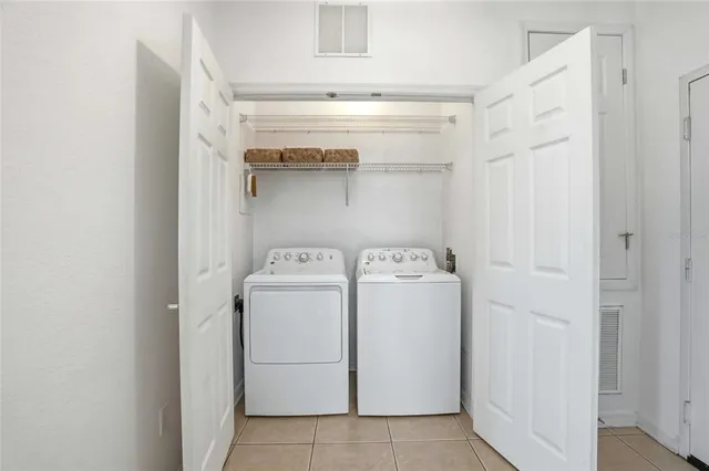 a view of a chandelier fan and refrigerator in a room