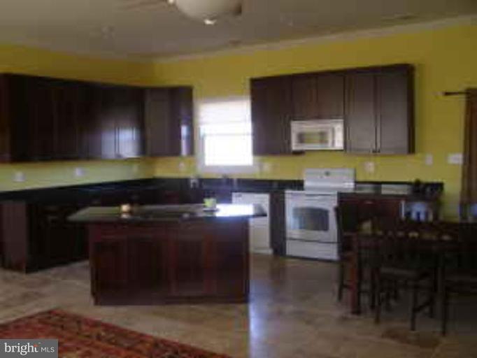 571 Messick Road Strasburg, VA 22657 - Photo 4 of 5 a kitchen with a cabinets and chairs
