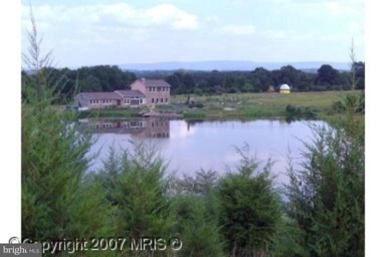 571 Messick Road Strasburg, VA 22657 - Photo 5 of 5 an aerial view of a house with garden and lake view