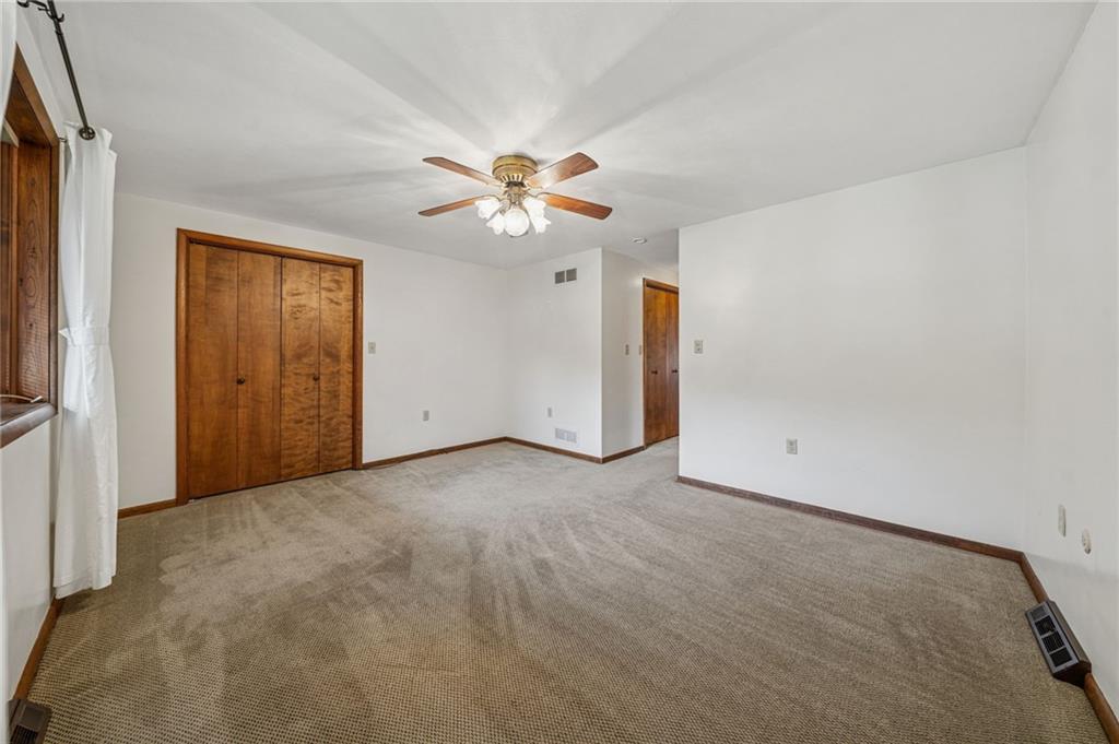 12219 Roth Drive Irwin, PA 15642 - Photo 29 of 48 an empty room with chandelier fan and windows