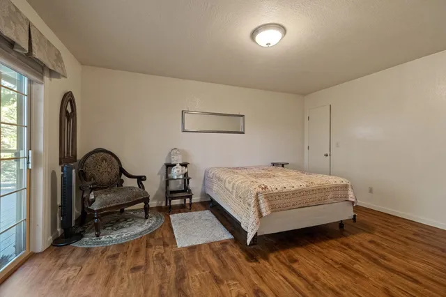 a bedroom with a bed and wooden floor