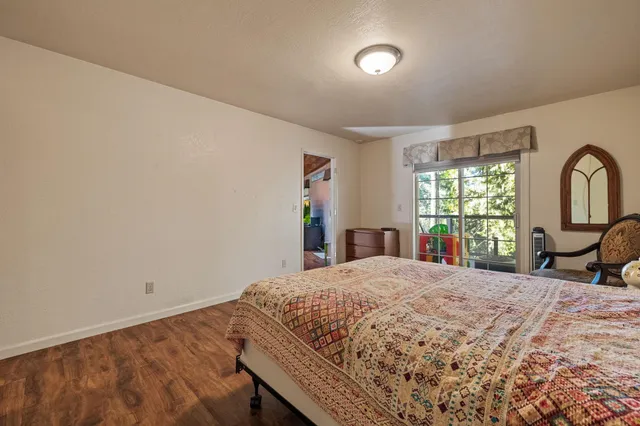 a bedroom with a bed and a large window