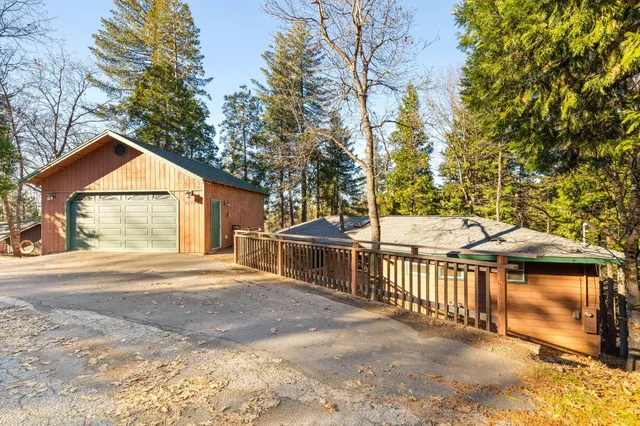 a view of a house with a yard and garage