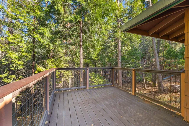 a view of balcony with wooden floor and fence