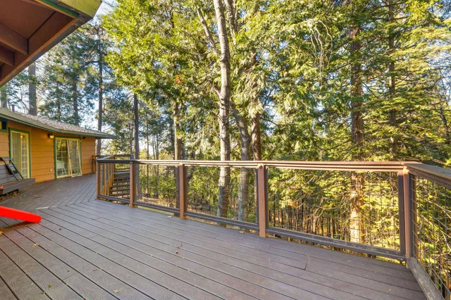 a view of a deck with wooden floor and fence