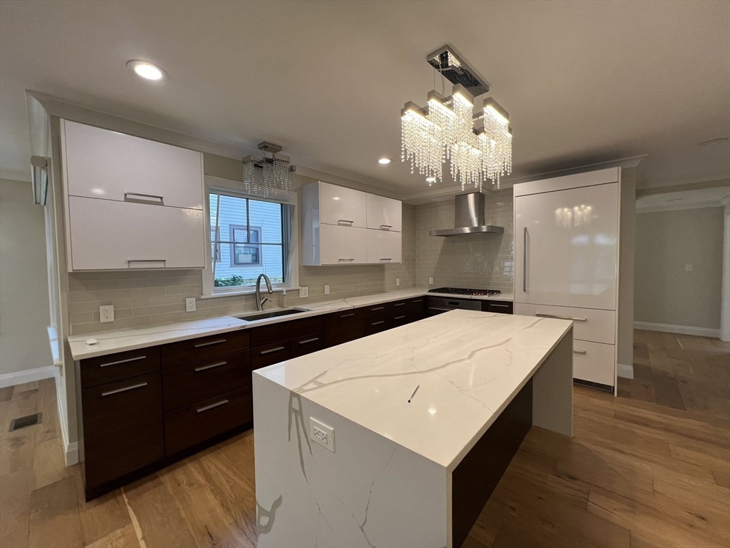 23 Winslow Road, Unit 1 Brookline, MA 02446 - Photo 6 of 27 a kitchen with a stove a sink and a refrigerator