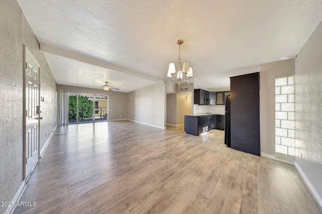 a view of a kitchen with furniture and wooden floor