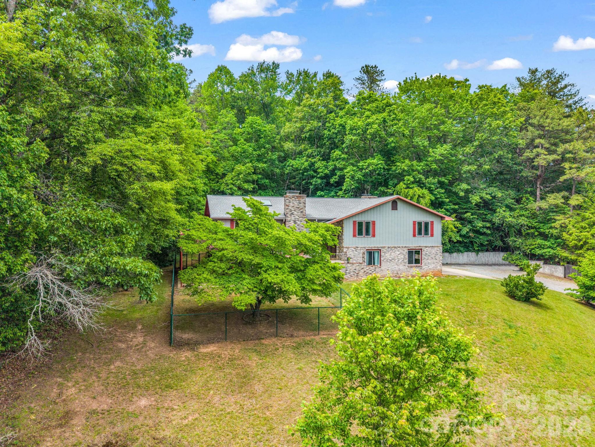 656 Cashiers Valley Road Brevard, NC 28712 - Photo 34 of 37 a view of a garden with a house in the background