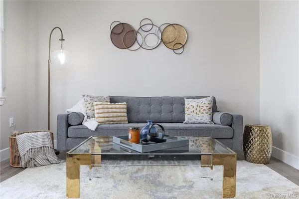 a living room with furniture chandelier and a large window