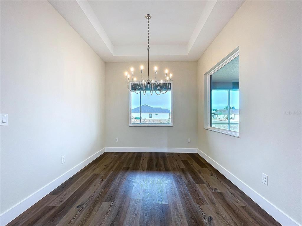 9065 Mississippi Run Weeki Wachee, FL 34613 - Photo 16 of 86 a view of an empty room with wooden floor and a window