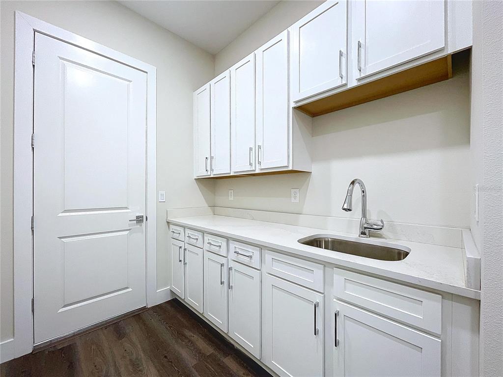 9065 Mississippi Run Weeki Wachee, FL 34613 - Photo 18 of 86 a kitchen with a sink cabinets and wooden floor