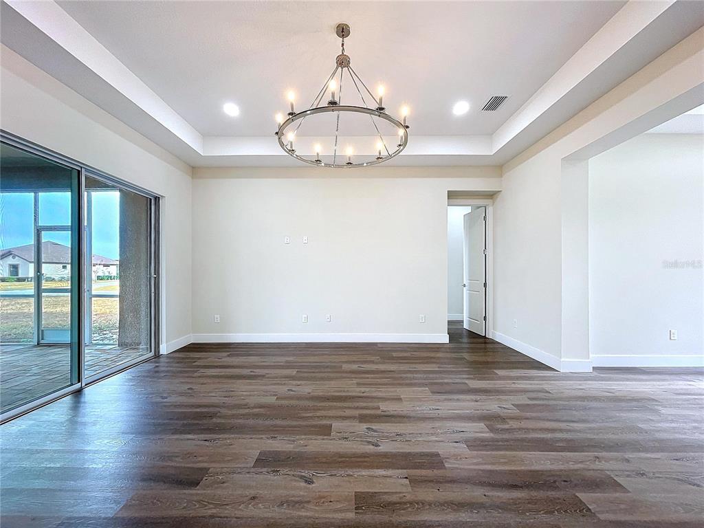 9065 Mississippi Run Weeki Wachee, FL 34613 - Photo 40 of 86 a view of an empty room with wooden floor and a window