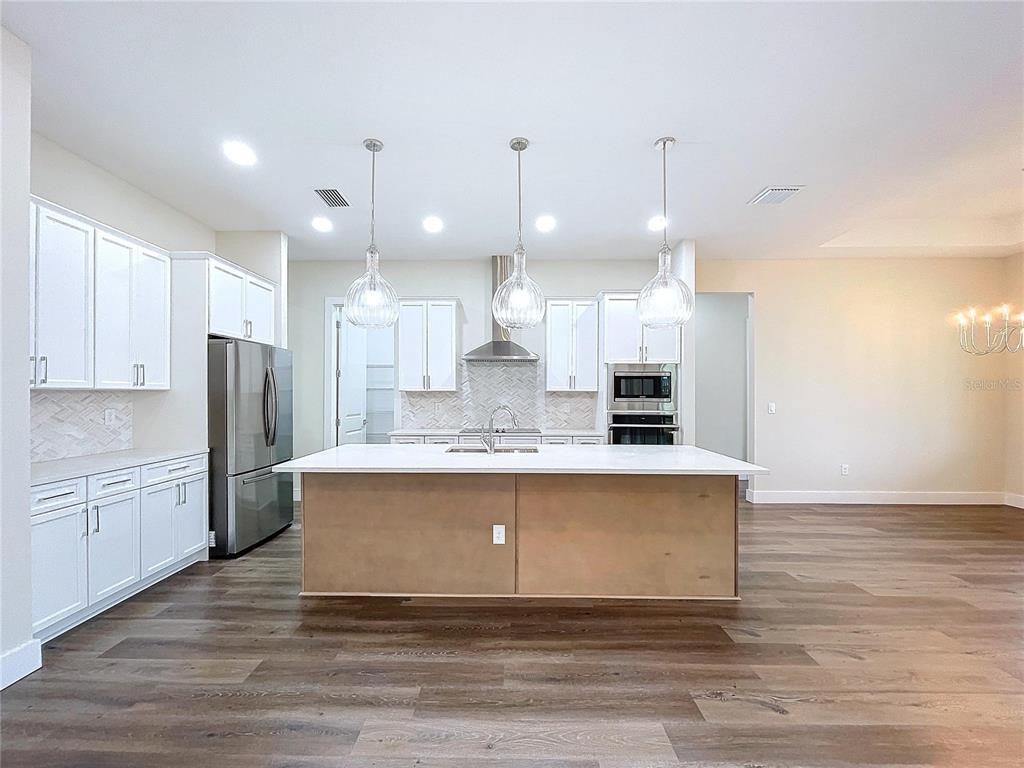 9065 Mississippi Run Weeki Wachee, FL 34613 - Photo 42 of 86 a view of kitchen with kitchen island and stainless steel appliances
