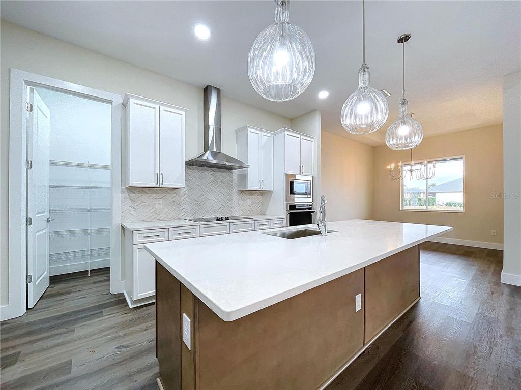 9065 Mississippi Run Weeki Wachee, FL 34613 - Photo 43 of 86 a kitchen that has a lot of cabinets in it