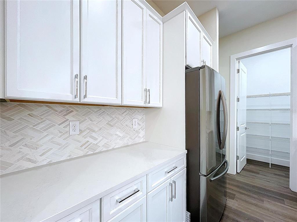 9065 Mississippi Run Weeki Wachee, FL 34613 - Photo 46 of 86 a kitchen with stainless steel appliances a refrigerator and cabinets