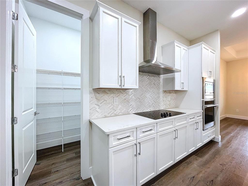 9065 Mississippi Run Weeki Wachee, FL 34613 - Photo 48 of 86 a kitchen with stainless steel appliances granite countertop a sink and a stove next to a window